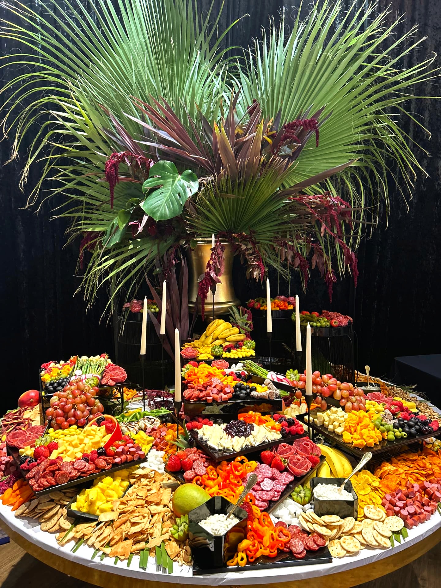 Vibrant catering spread with fresh fruits, cheeses, and charcuterie